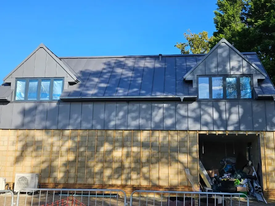 Steel standing seam roof and upper facade on a contemporary residential extension