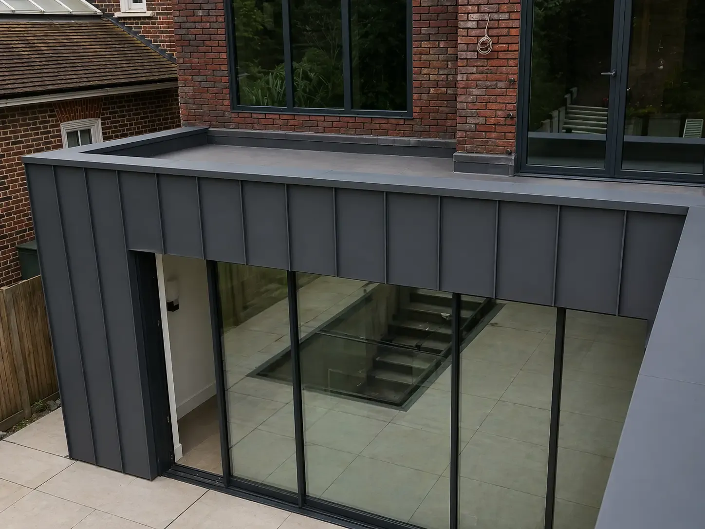Steel fascia and soffit details above sliding doors on a rear extension