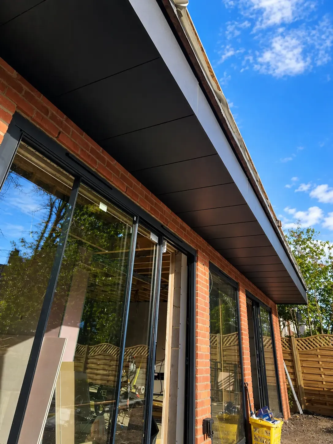 Aluminium soffit and fascia detail along a glazed residential extension
