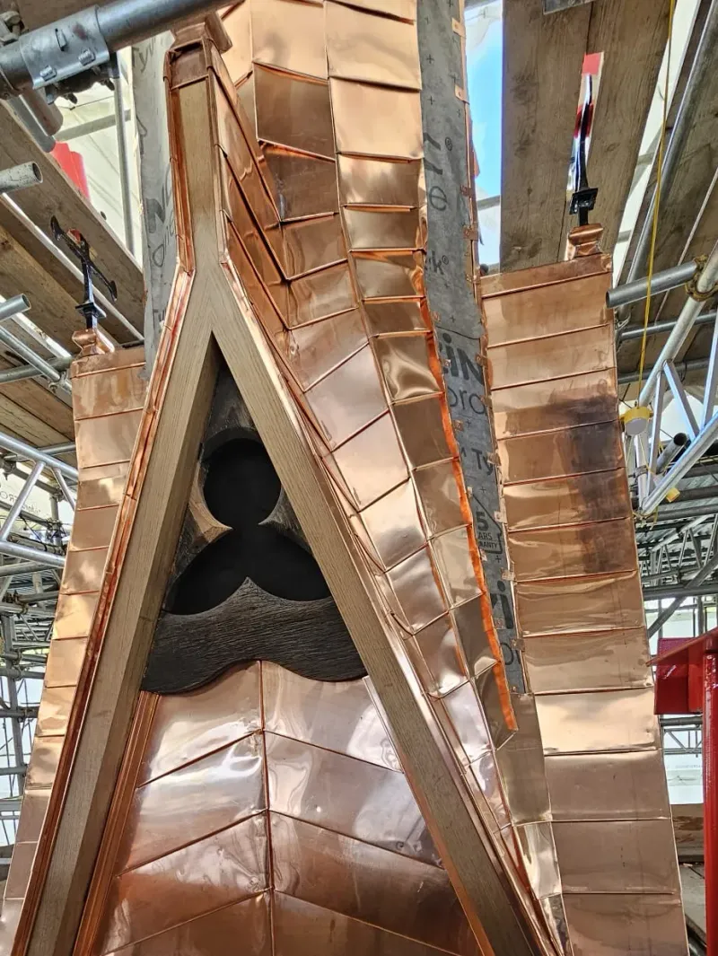 Copper standing seam detail on a complex tapered spire junction