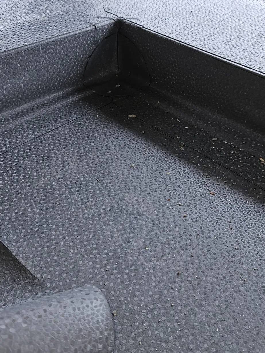Close-up of a single-ply membrane corner and upstand detail